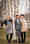 Three learners from different areas are leaning against a tree outside. Behind them you can see part of the Hotel Grand Resort Bad Ragaz, a star hotel in Switzerland.